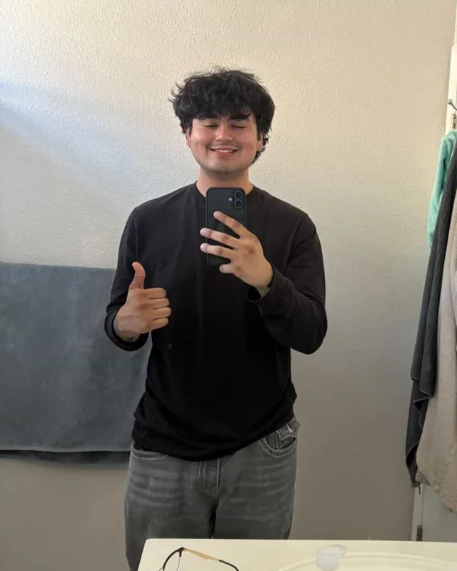 Jose smiling in a black shirt and giving a thumbs-up after losing 60 pounds